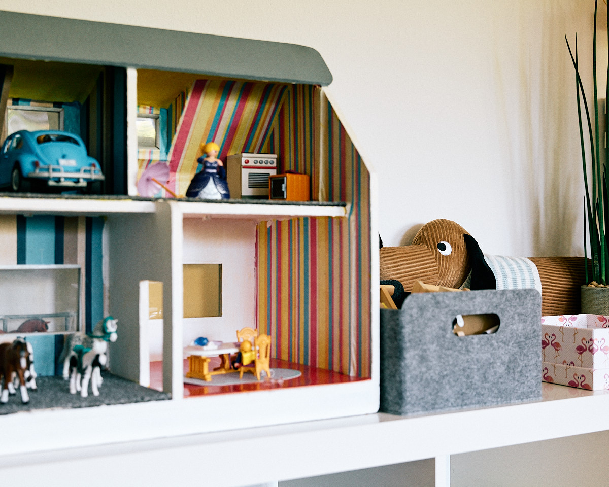 Puppenhaus mit modernem Stoff-Dackel als Detail im Raum